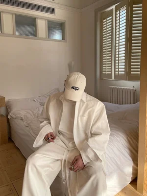 Off-white oversized cotton poplin shirt styled with matching wide-leg pants in a relaxed Korean streetwear bedroom look