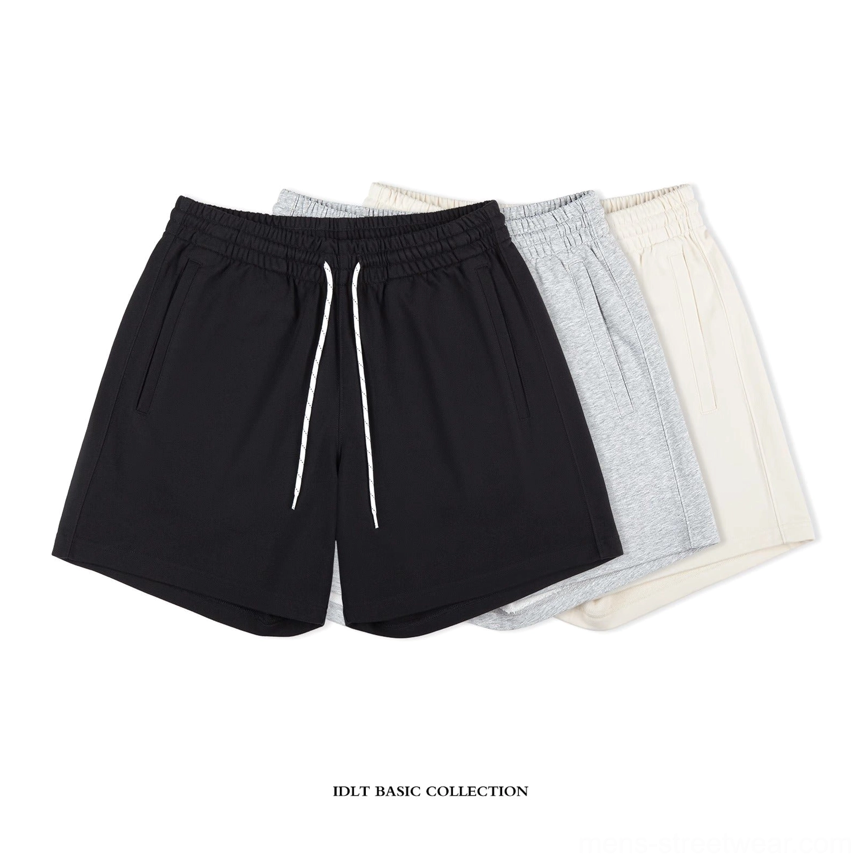 Collection of black heather gray and apricot oversized cotton sweat shorts in a minimalist streetwear presentation