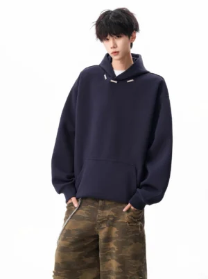 Navy oversized drop shoulder hoodie with metal hood buckle trims, kangaroo pocket, and camo wide-leg streetwear pants