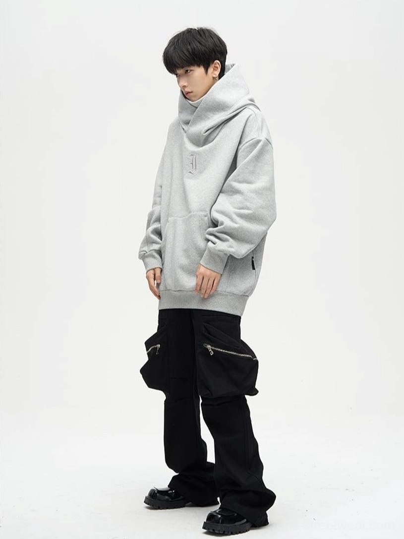 Gray oversized dual-layer high-neck hoodie styled with black cargo pants in a white studio streetwear outfit