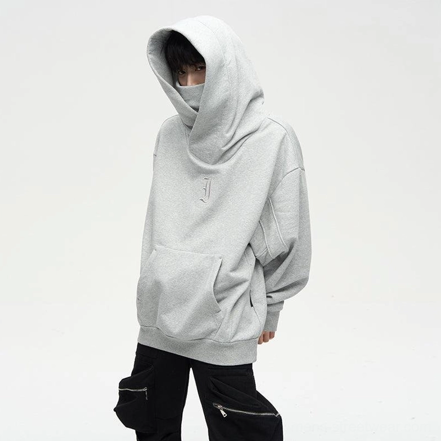 Gray oversized dual-layer high-neck hoodie with hood raised showing face-shield silhouette and relaxed streetwear sleeves