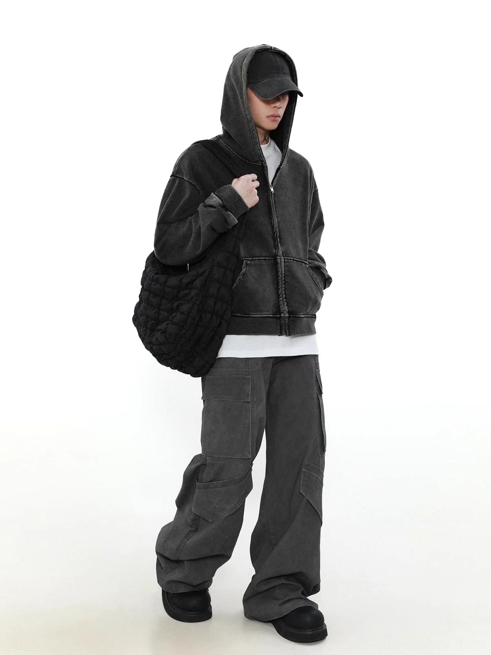 Oversized faded black vintage zip-up hoodie side view with attached hood dropped shoulders and relaxed Korean streetwear silhouette