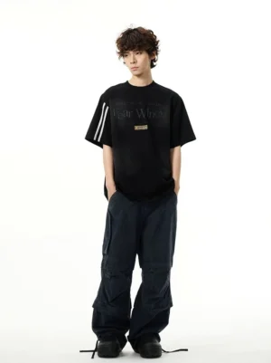 Full body styling of oversized graphic streetwear T-shirt with black cargo pants and sporty sleeve stripes