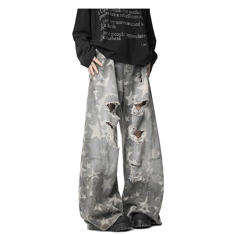 Oversized grey star print distressed baggy jeans side three quarter view with wide leg silhouette