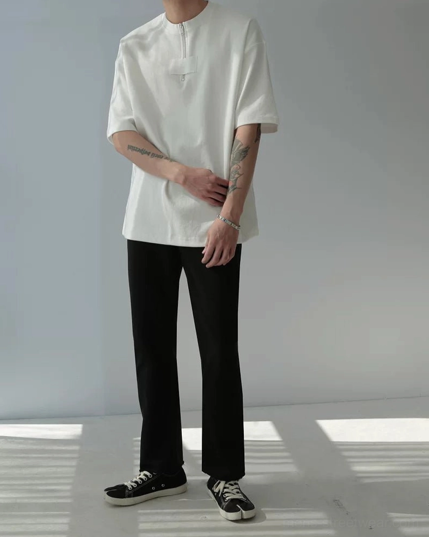 Side front full-body view of oversized half-zip cotton tee showing relaxed boxy short sleeve fit