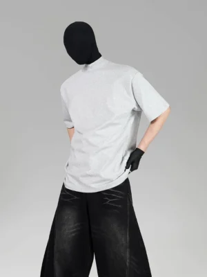 Left three-quarter view of oversized heather gray cotton tee with relaxed boxy fit and wide-leg washed denim Korean streetwear styling