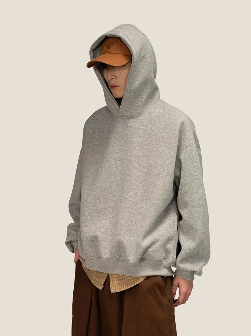 Oversized heather gray fleece hoodie with dropped shoulders styled with wide-leg trousers for Seoul streetwear