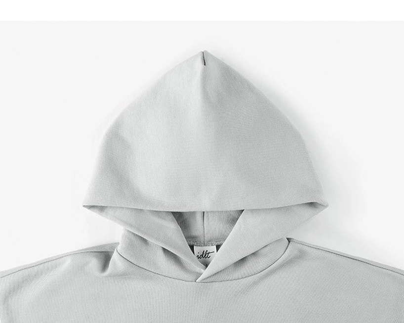 Close-up view of the oversized hoodie neckline, hood stitching, and soft cotton-rich fabric