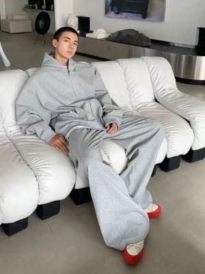 Oversized light grey zip-up hoodie with matching sweatpants in a relaxed Seoul streetwear outfit, front full-body view