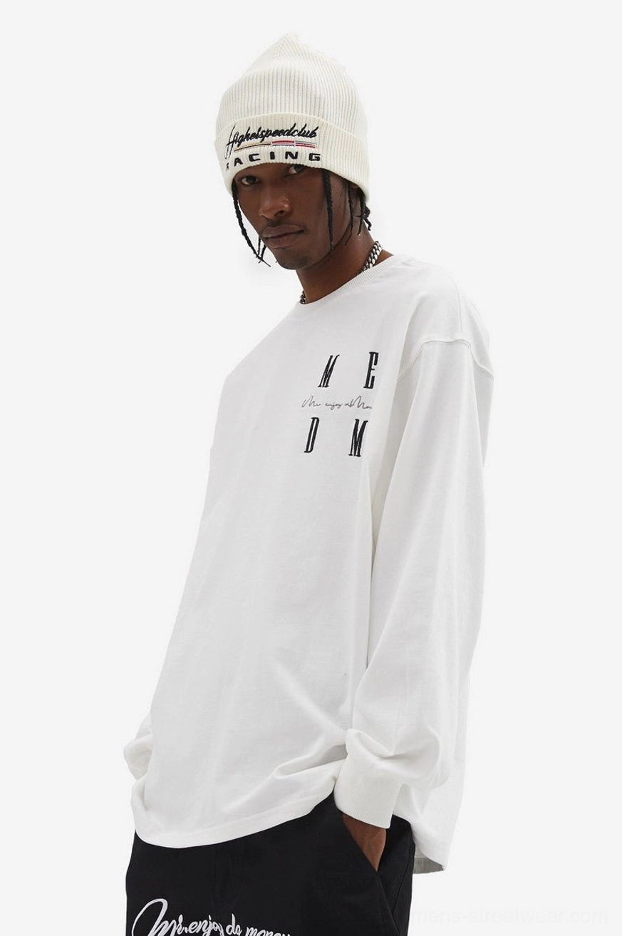White oversized MCDM graphic long sleeve T-shirt styled with black trousers and a white knit beanie in Korean streetwear fashion