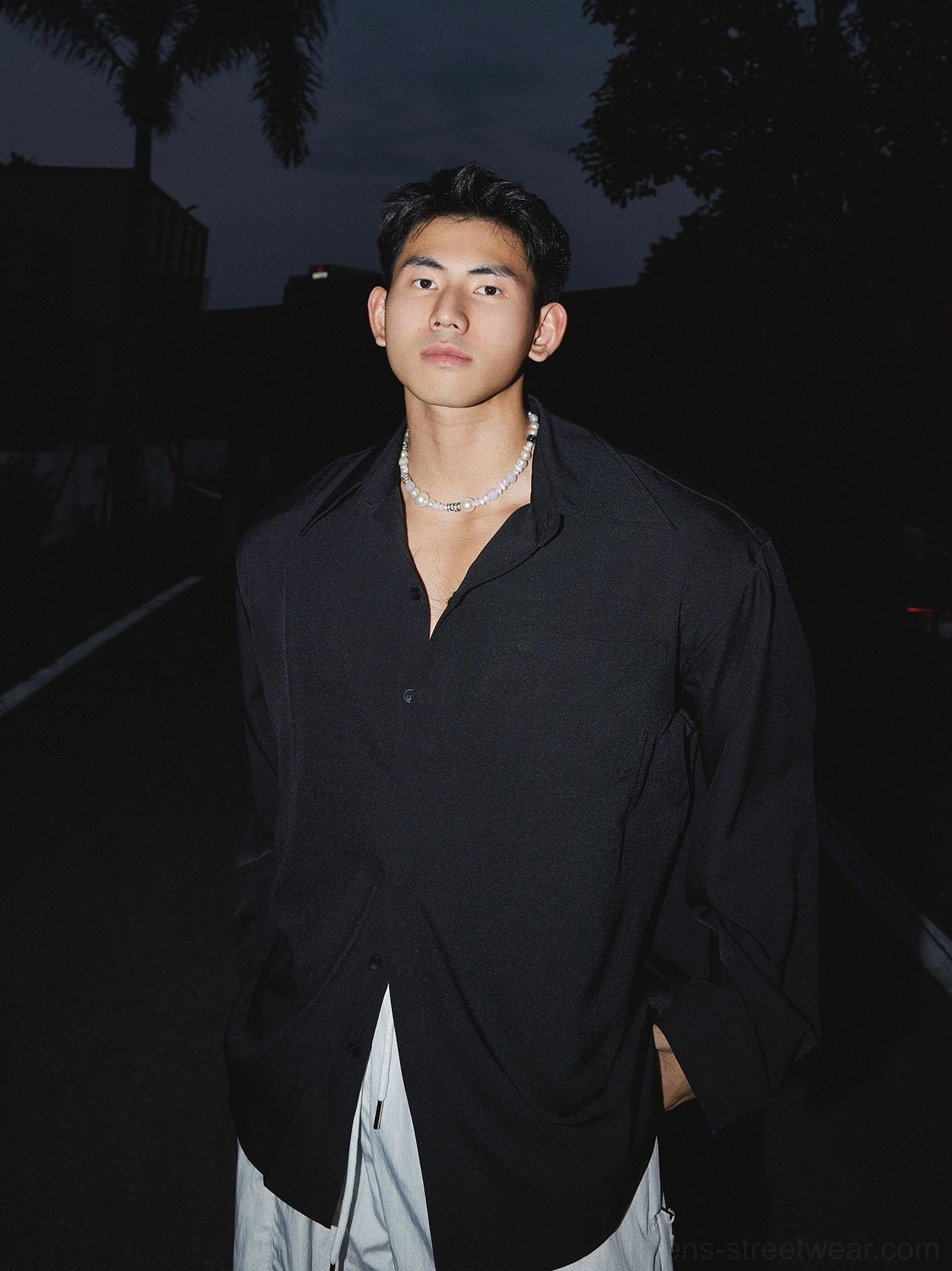 Black oversized men's streetwear dress shirt with button front pointed collar and relaxed Korean fashion silhouette