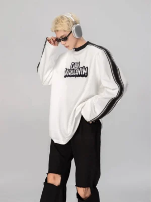 Oversized white monochrome stripe varsity graphic long sleeve tee side view with drop shoulders and contrast sleeve panels