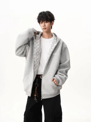 Heather gray oversized monogram-lined full-zip streetwear hoodie worn by male model in front three-quarter view
