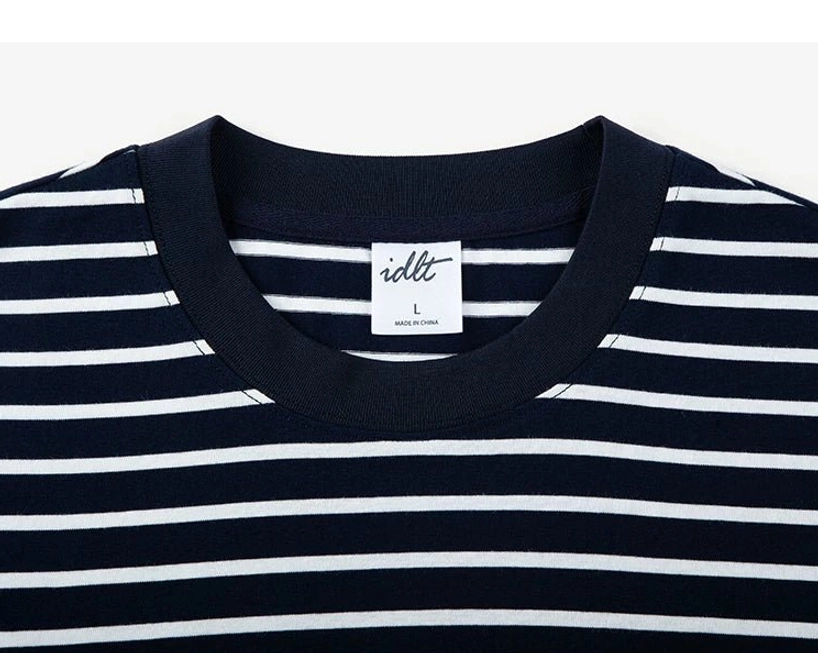 Close-up of black and white stripe cotton fabric with ribbed black crew neckline