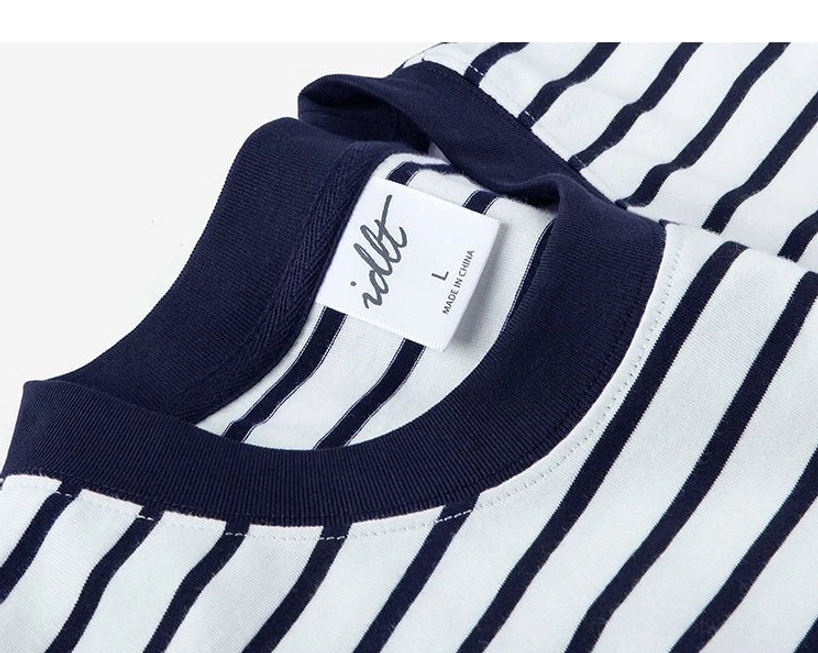 Close-up of ribbed navy crew neck collar on oversized nautical stripe cotton streetwear T-shirt