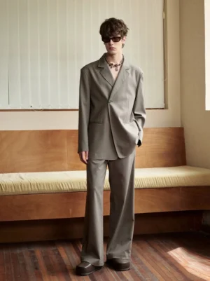 Men's taupe grey oversized notch lapel casual blazer styled with matching wide leg suit trousers in a full body streetwear studio view