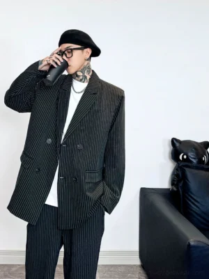 Close three-quarter view of a relaxed oversized pinstripe blazer with wide peak lapels and double-breasted front in modern streetwear styling