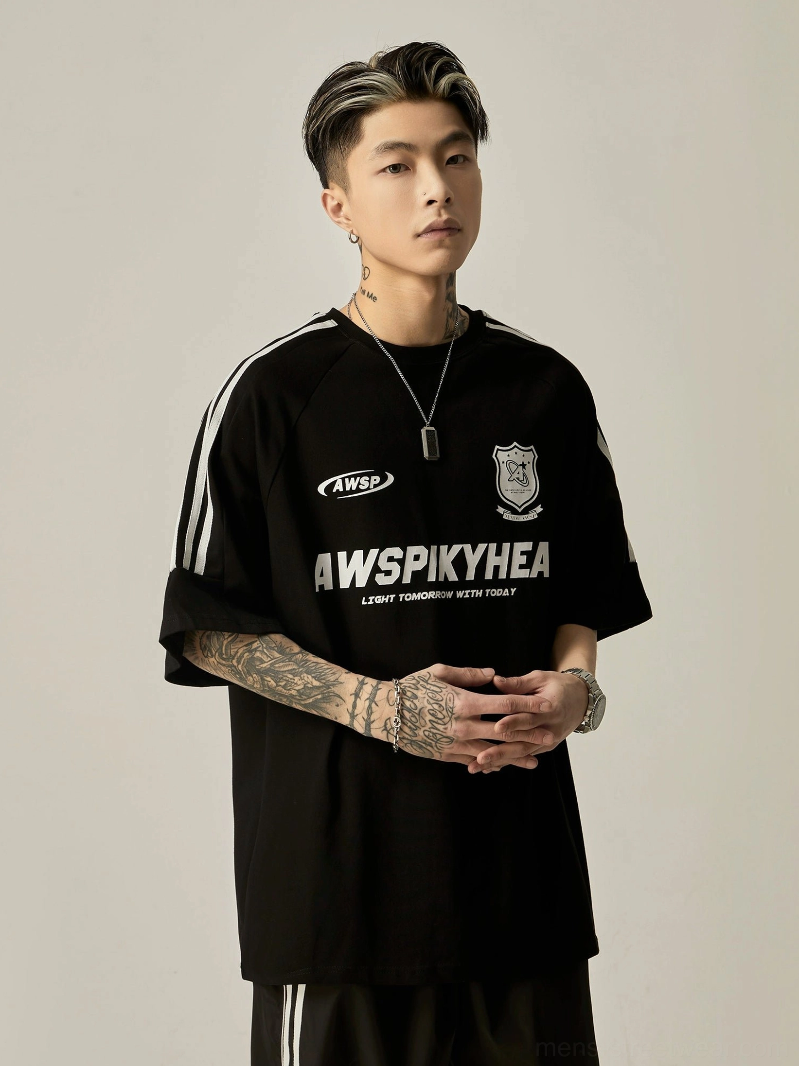 Oversized black athletic raglan graphic tee front portrait view with white stripe trim on raglan sleeves and front brand printed graphics