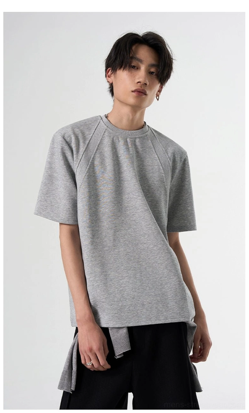 Heather gray raglan sleeve streetwear T-shirt styled with black wide-leg pants and a layered hem