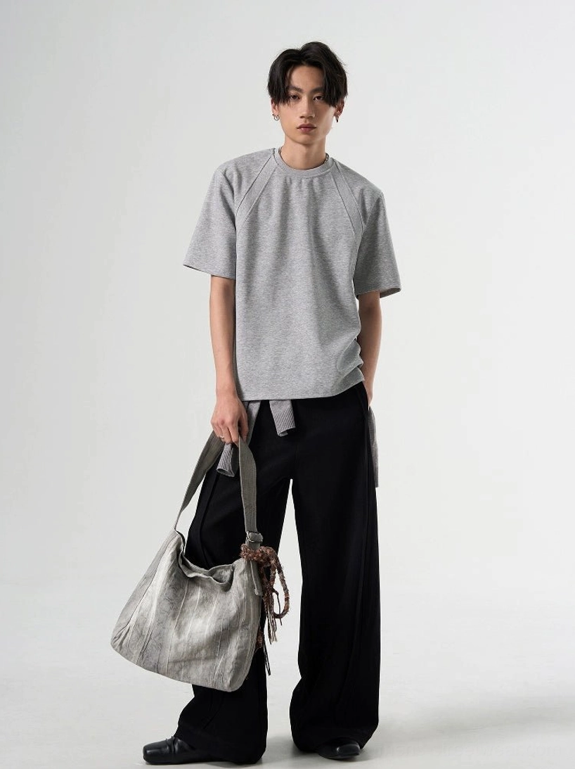 Heather gray oversized raglan sleeve T-shirt shown in a full-body front view with relaxed Korean streetwear styling and a silver tote bag