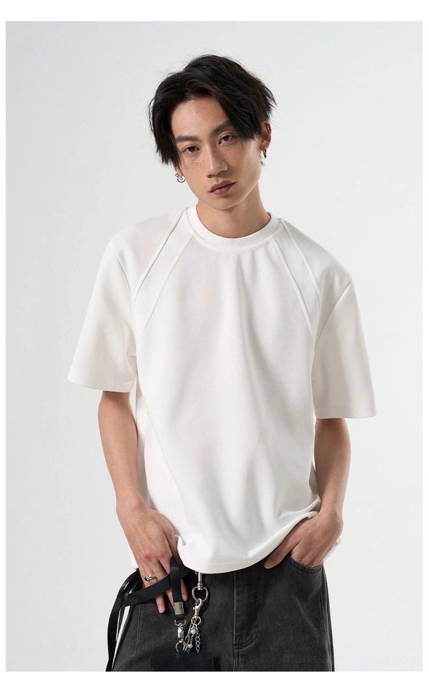 White Korean streetwear raglan T-shirt shown from the front with structured shoulders and dark gray chain-detail trousers