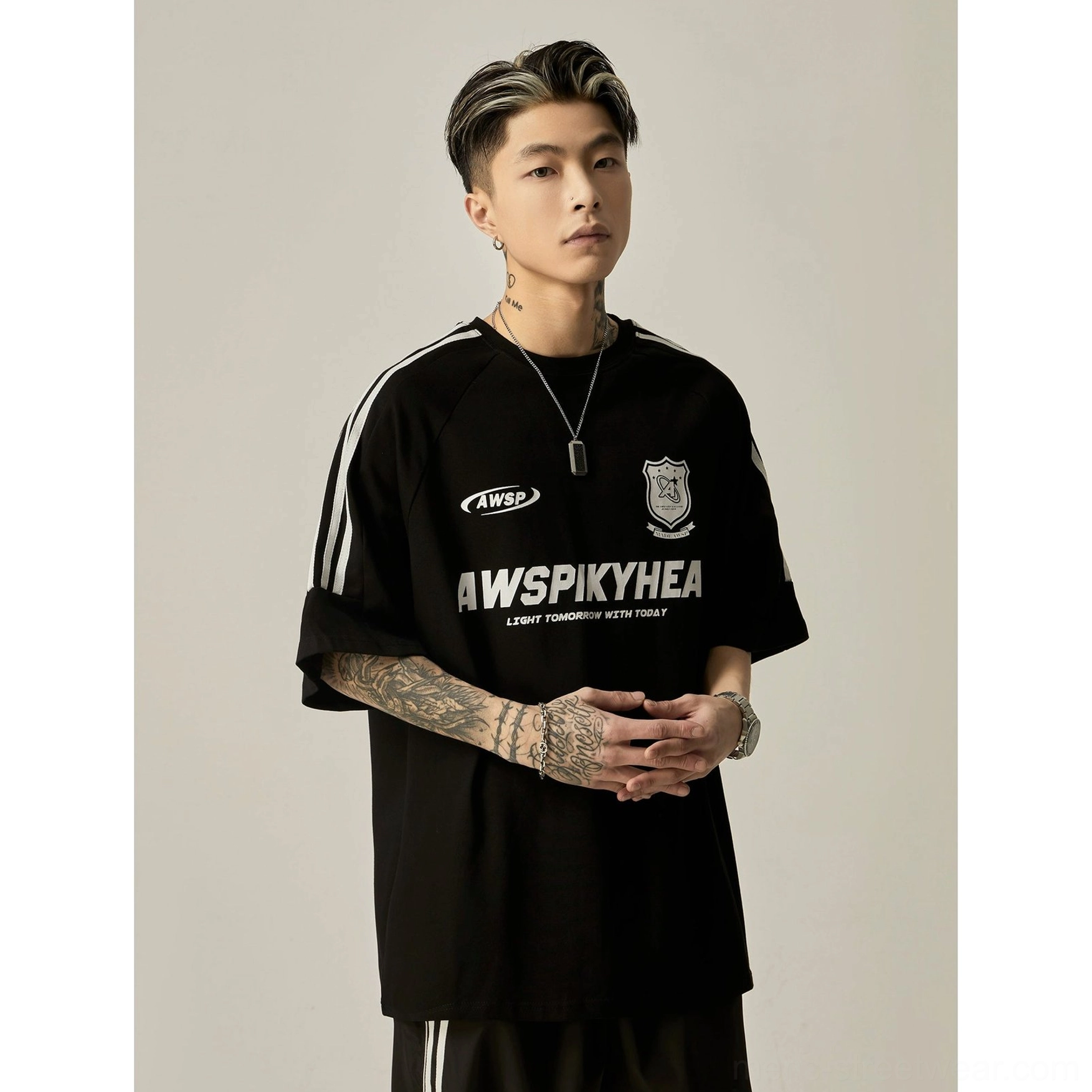 Oversized black raglan athletic graphic tee complete front view showing jet black fabric with white stripe sleeve accents