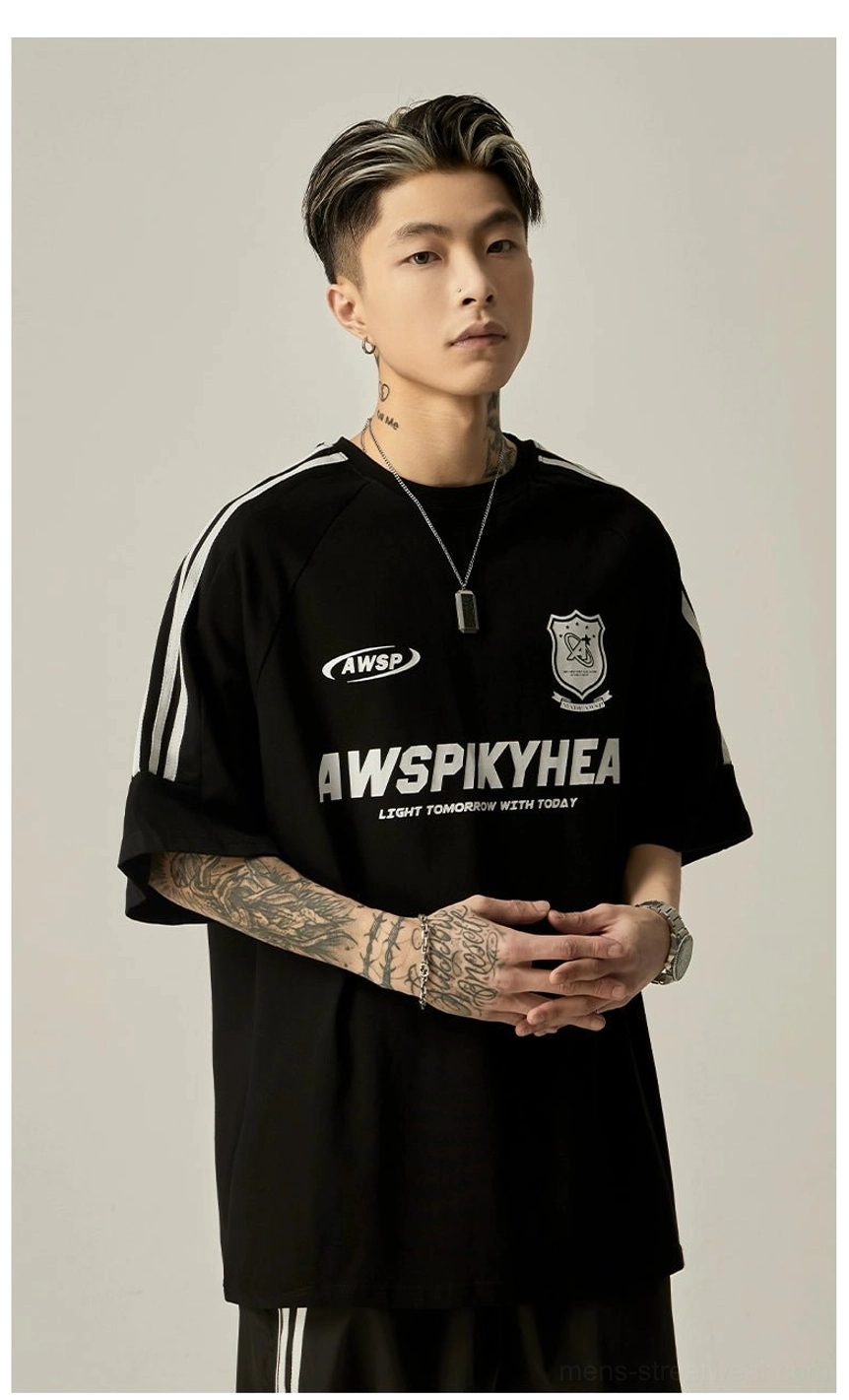 Oversized raglan athletic graphic tee styled layering look demonstrating versatility with outerwear and streetwear coordination