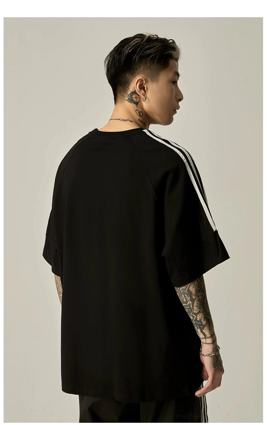 Oversized raglan athletic graphic tee size comparison showing different size options M L XL 2XL proportions