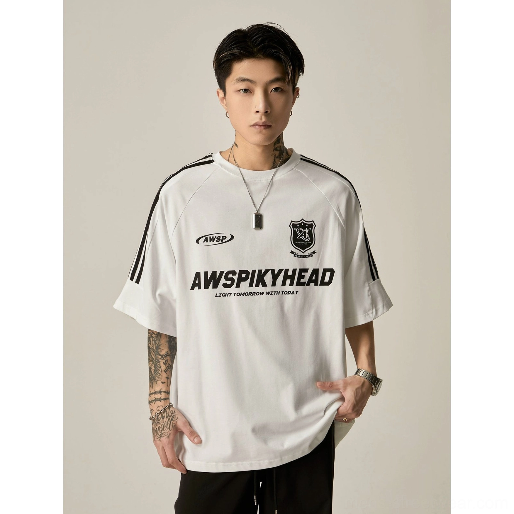 Oversized white raglan athletic graphic tee lifestyle photo demonstrating everyday streetwear wear and styling potential