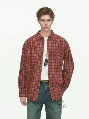 Red oversized plaid button-up shirt layered over a white tee with loose blue jeans in a full-body Korean streetwear outfit