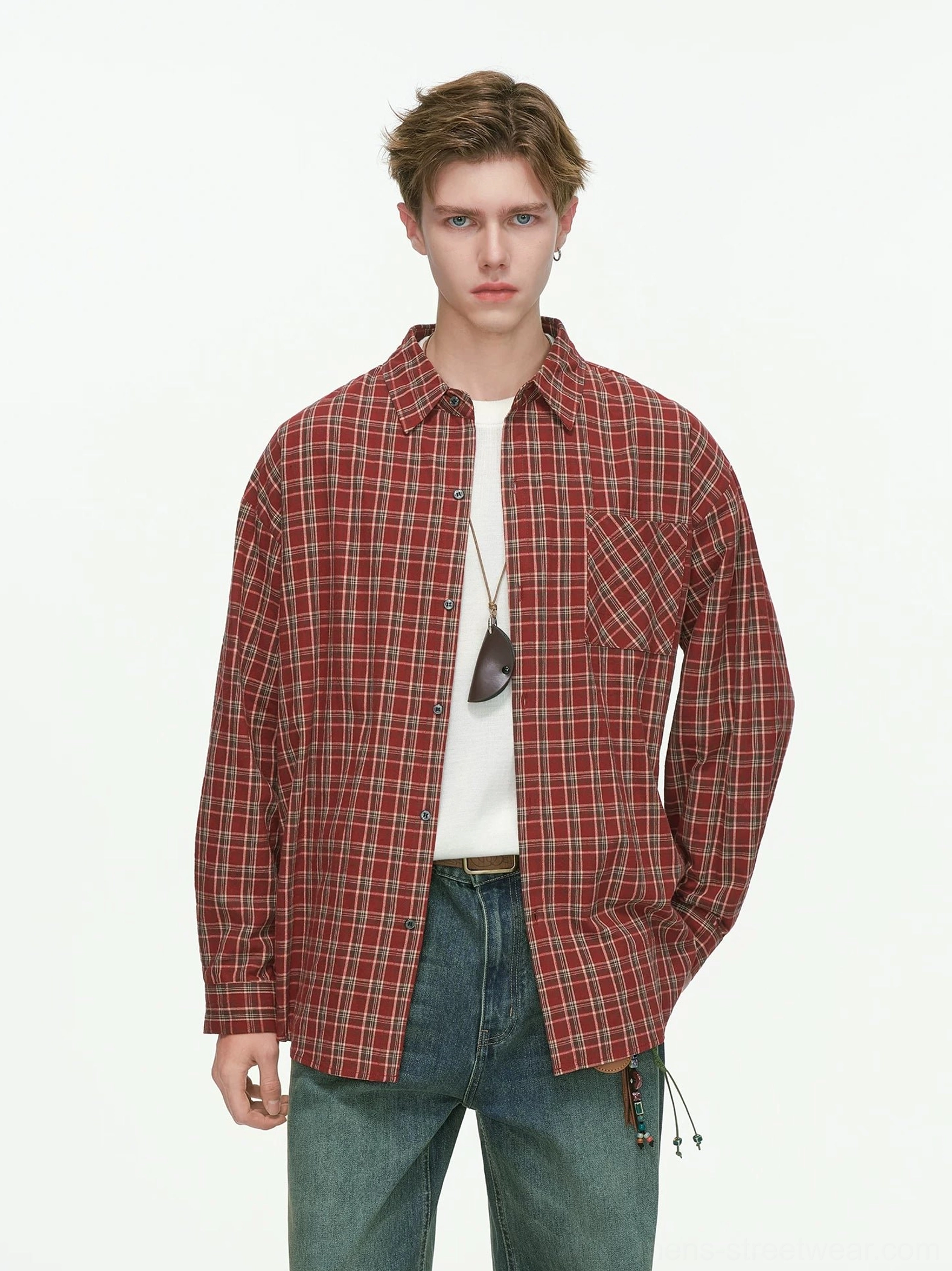 Red oversized plaid button-up shirt layered over a white tee with loose blue jeans in a full-body Korean streetwear outfit