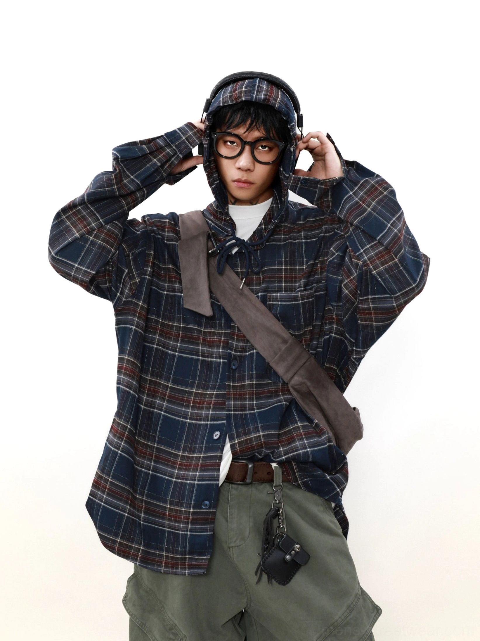 Close front view of an oversized red and white check plaid hooded shirt layered over a white T-shirt with long relaxed sleeves
