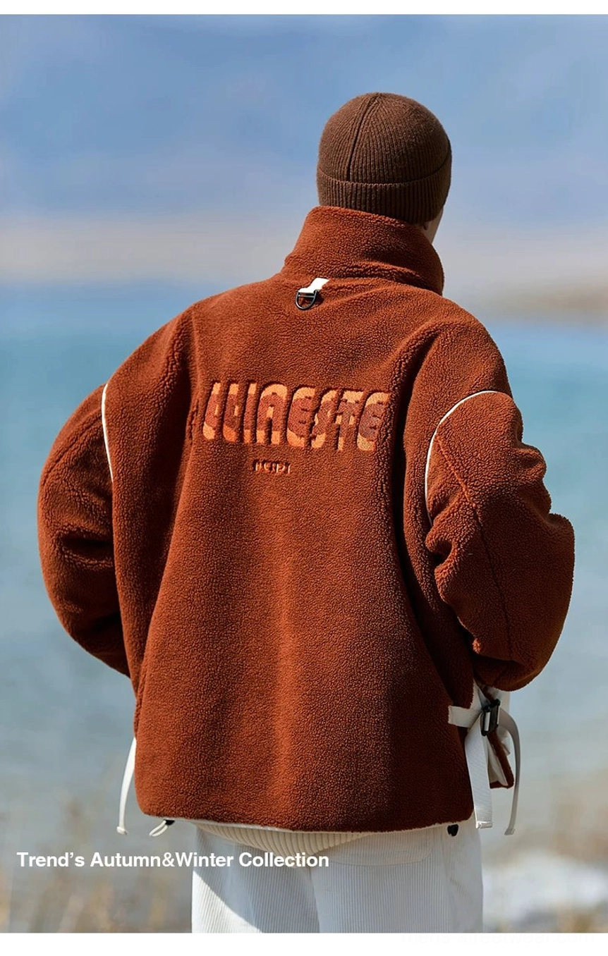 Back view of an oversized sherpa expedition jacket showing rear letter detail, dropped shoulders, and side drawstring adjustment