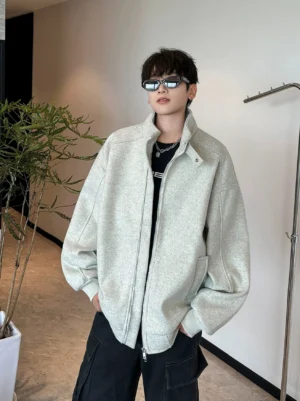 Apricot oversized stand collar zip jacket with dropped shoulders and relaxed Korean streetwear silhouette indoors