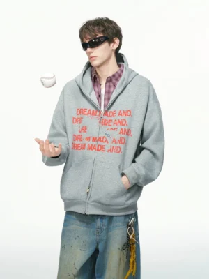 Heather grey oversized statement graphic full-zip streetwear hoodie front three-quarter view with red typography print
