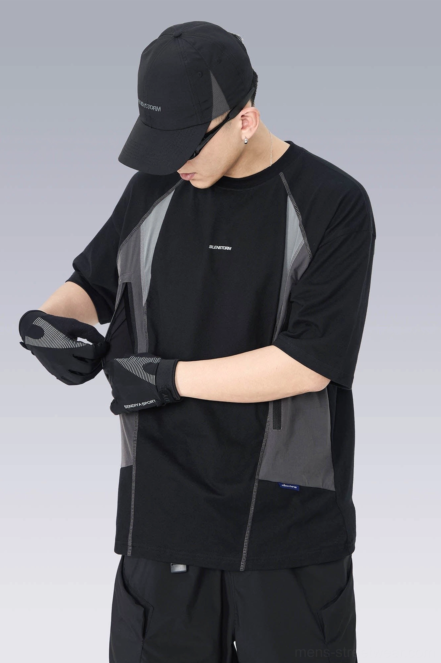 Left side profile of an oversized tech short-sleeve T-shirt with dark grey contrast panels, crew neckline, cap, and gloves