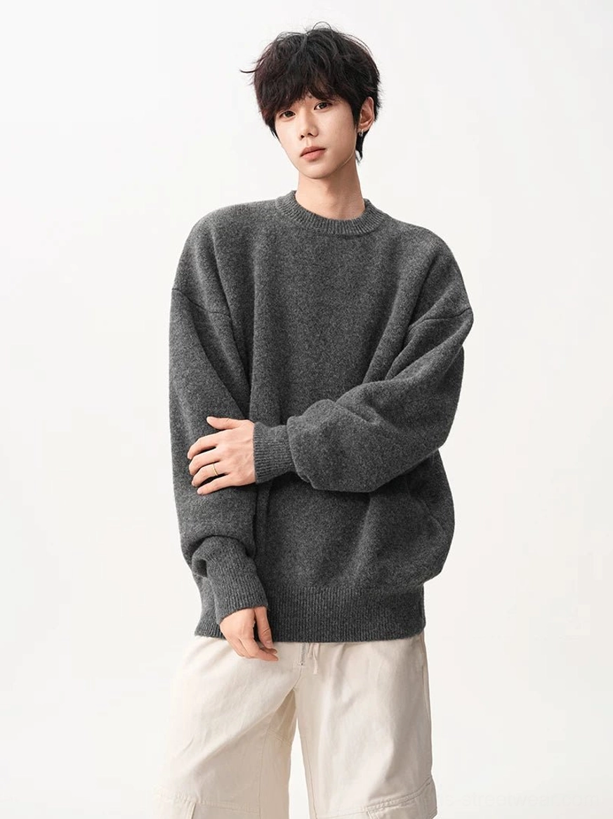 Oversized textured knit sweater in dark gray and dark brown, showcasing the relaxed crew neck streetwear silhouette and ribbed finish
