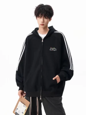 Black oversized triple stripe zip hoodie with embroidered chest detail shown in a full front studio outfit view