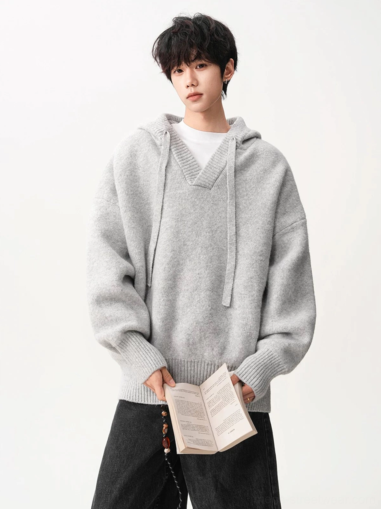 Light gray brown oversized V-neck knit hoodie with drop shoulders styled with black loose jeans in Korean streetwear look