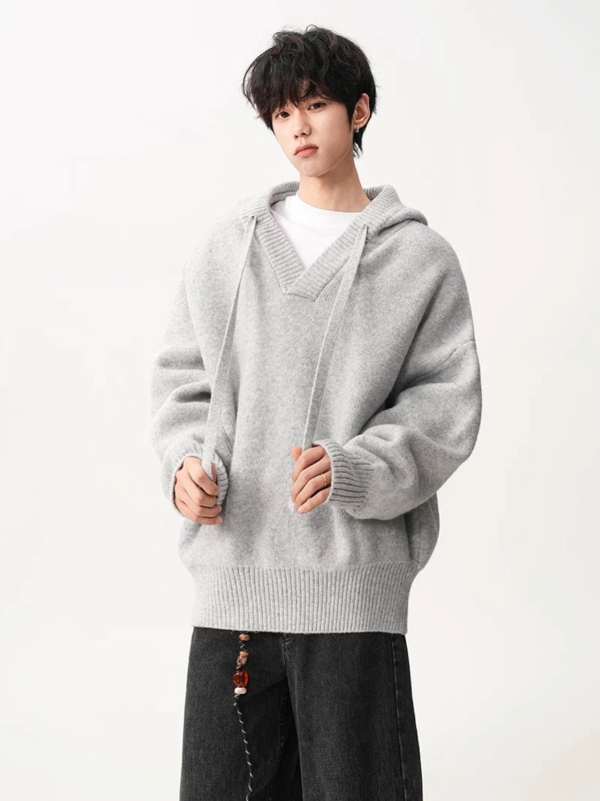 Light gray brown V-neck hooded knit sweater oversized fit layered over white tee and black denim