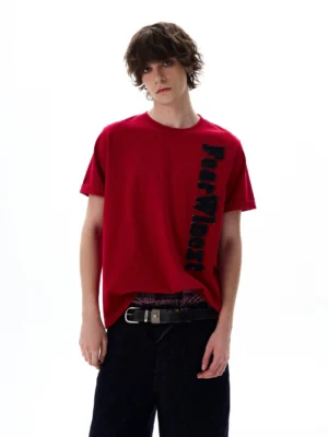 Oversized deep red vertical lettering T-shirt shown with black wide-leg trousers in a modern Seoul streetwear outfit