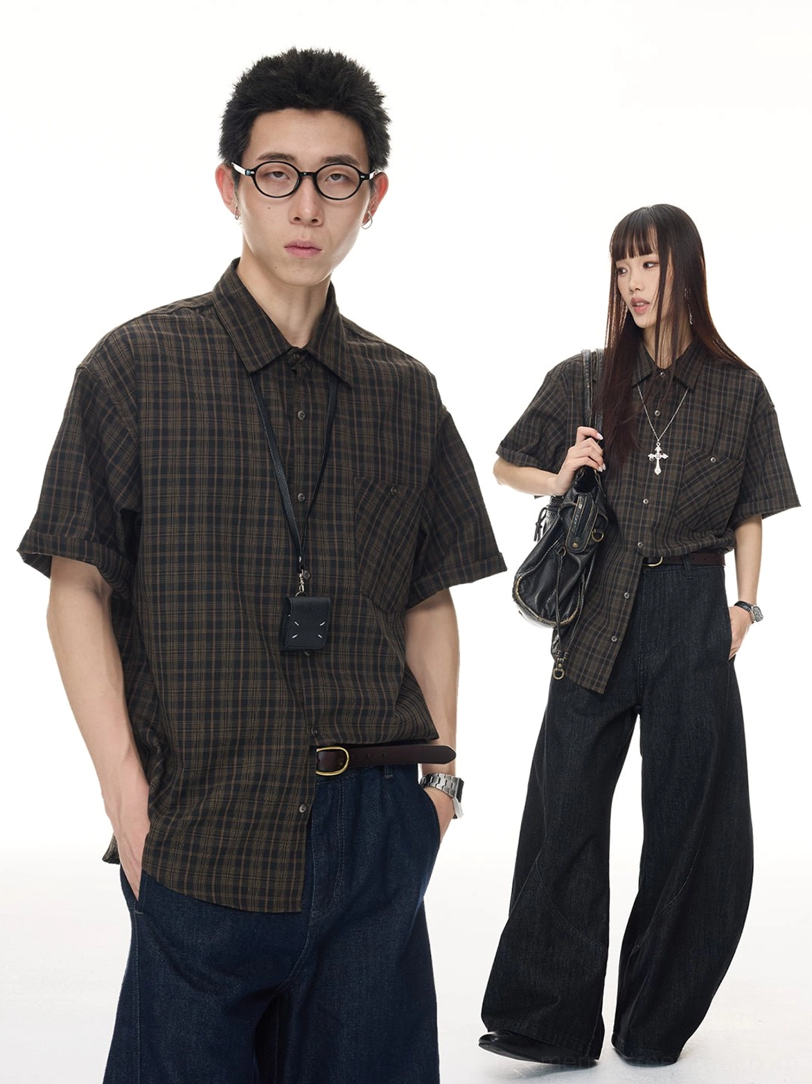 Male and female models wearing an oversized vintage brown plaid short sleeve streetwear shirt with dark wide leg denim