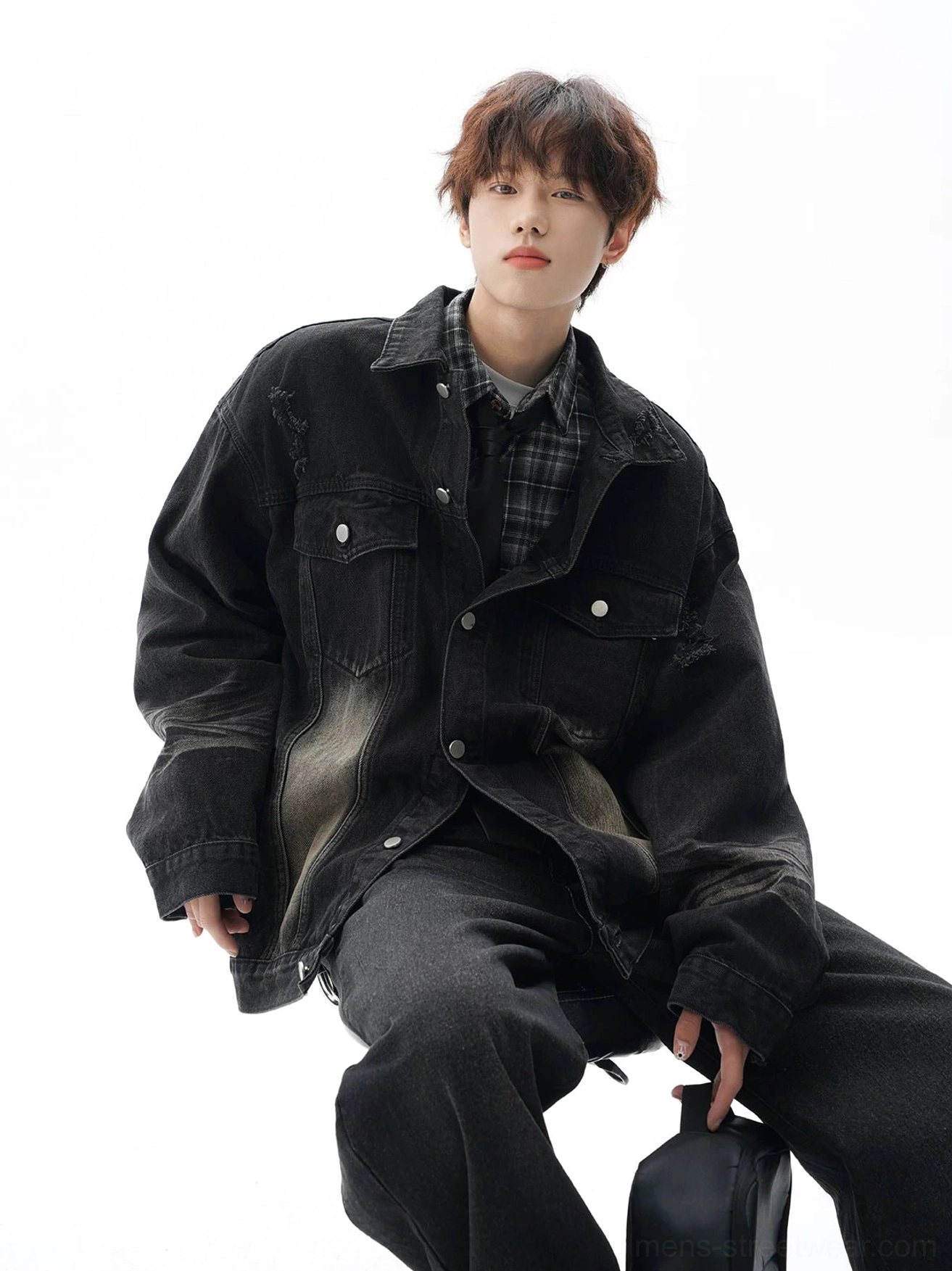 Oversized vintage distressed denim jacket with faded panel details, utility chest pockets, and contemporary unisex streetwear styling