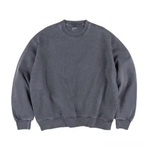 Oversized faded crewneck sweatshirt front view showing vintage washed cotton texture and loose streetwear fit