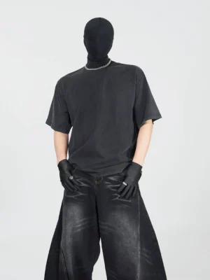 Front view of oversized washed charcoal black mock neck cotton tee styled with wide-leg washed gray denim in minimalist Korean streetwear look