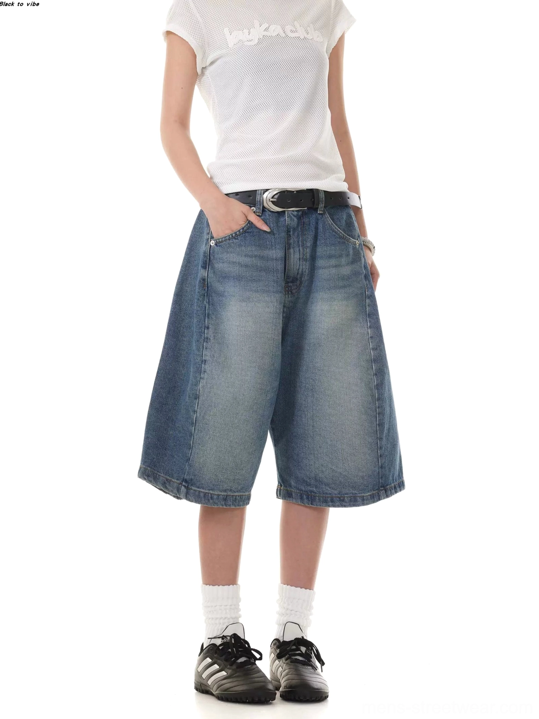 Oversized washed denim Bermuda shorts with wide cropped legs and classic front pockets in a front studio view