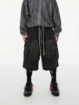 Front full-body view of oversized washed denim cargo long shorts with large cargo pockets, raw frayed hem, elastic drawstring waist, and relaxed Korean streetwear styling