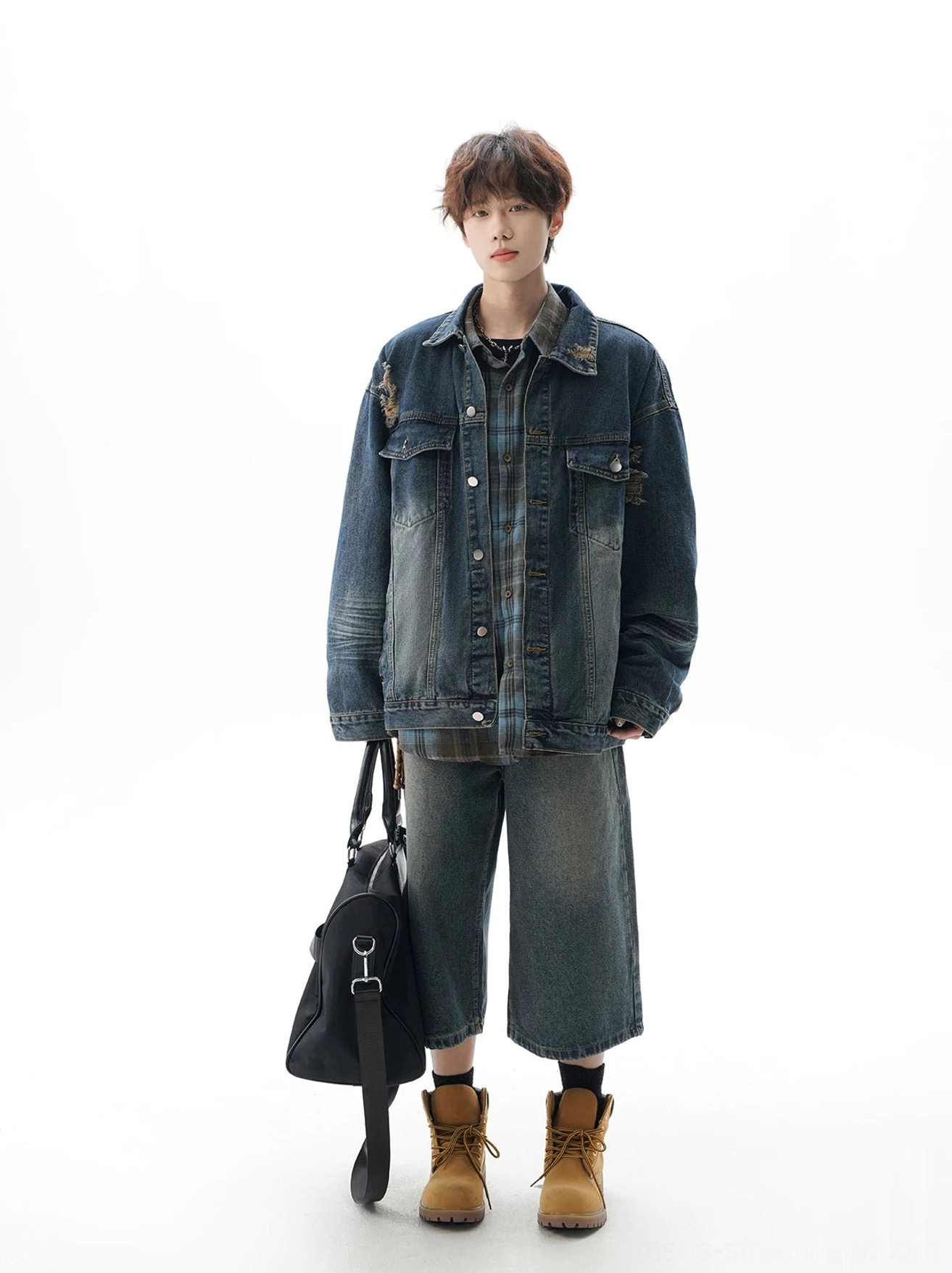 Oversized washed denim jacket with rugged workwear texture, distressed patch details, button closure, and adaptable everyday streetwear design