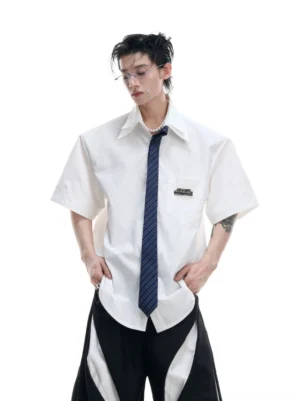 White oversized short sleeve shirt with dark blue necktie styled with black wide leg streetwear pants