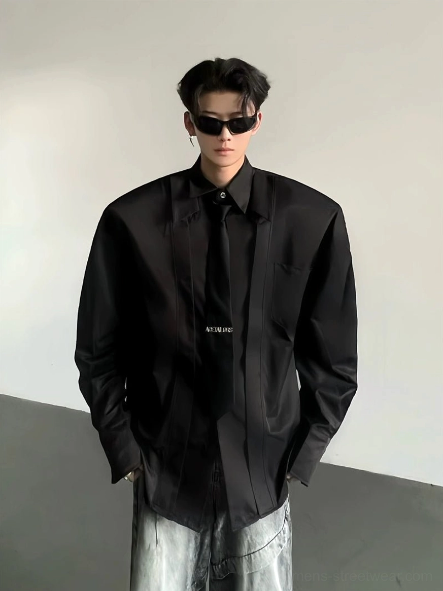 Close-up of black oversized wide-shoulder Korean streetwear dress shirt with smooth cotton blend fabric chest pocket and printed necktie